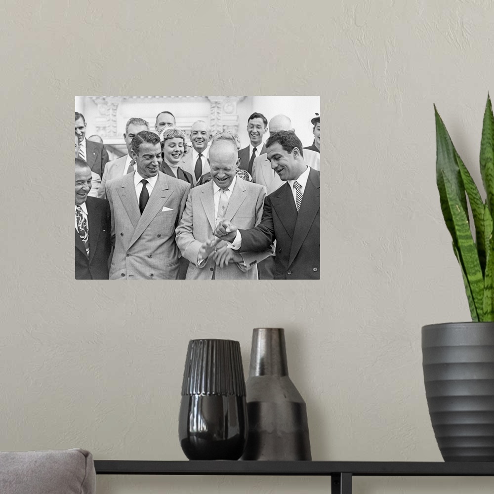 A modern room featuring President Eisenhower with baseball great Joe DiMaggio, and boxing champion, Rocky Marciano. June ...