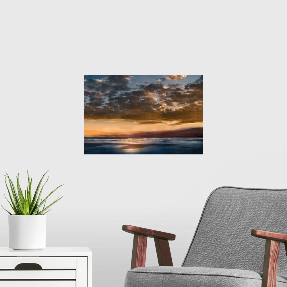 A modern room featuring Seascape photograph with mountains in the distance and a cloudy sky at sunset.