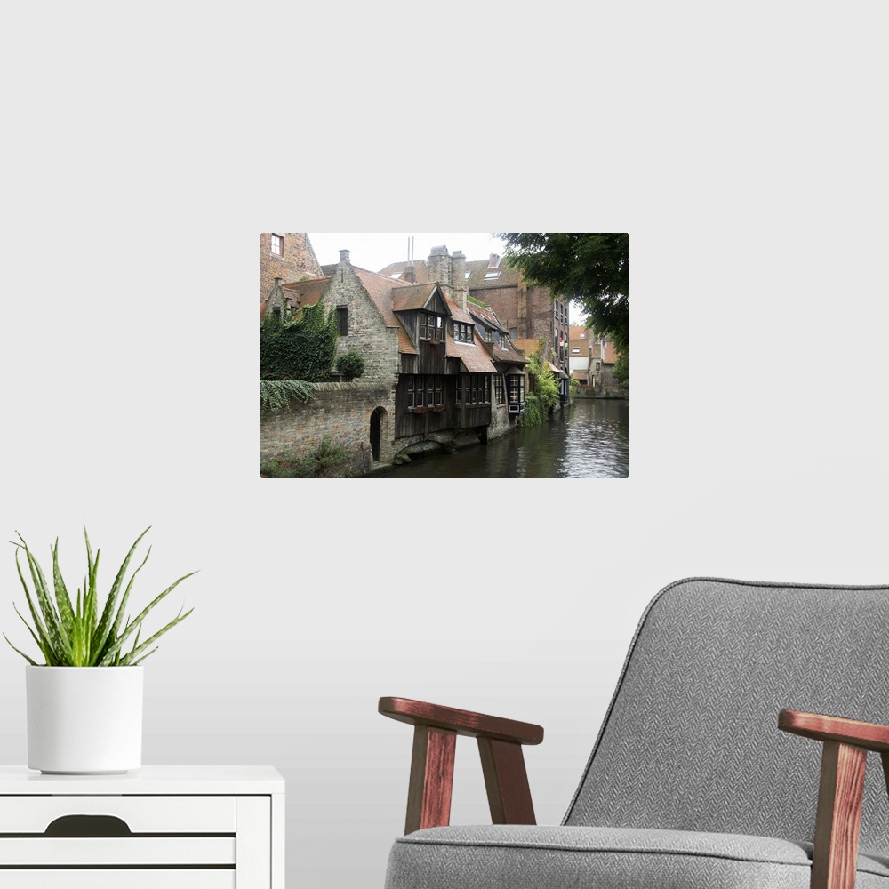 A modern room featuring Photograph of old houses on the edge of the river in Belgium.