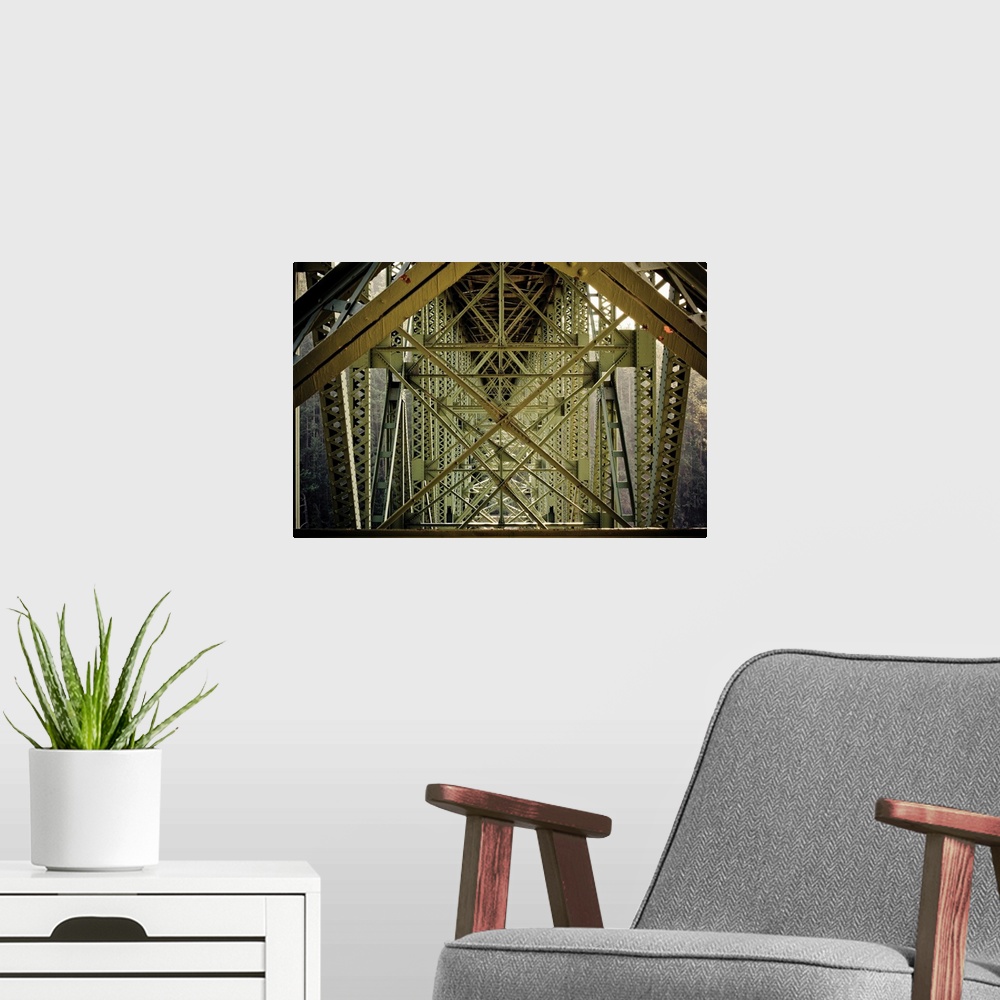 A modern room featuring Up-close photograph of architectural detail of iron bridge.