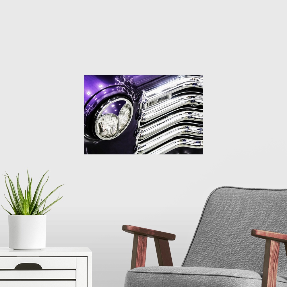 A modern room featuring Headlight and grill detail of a bright purple vintage truck.