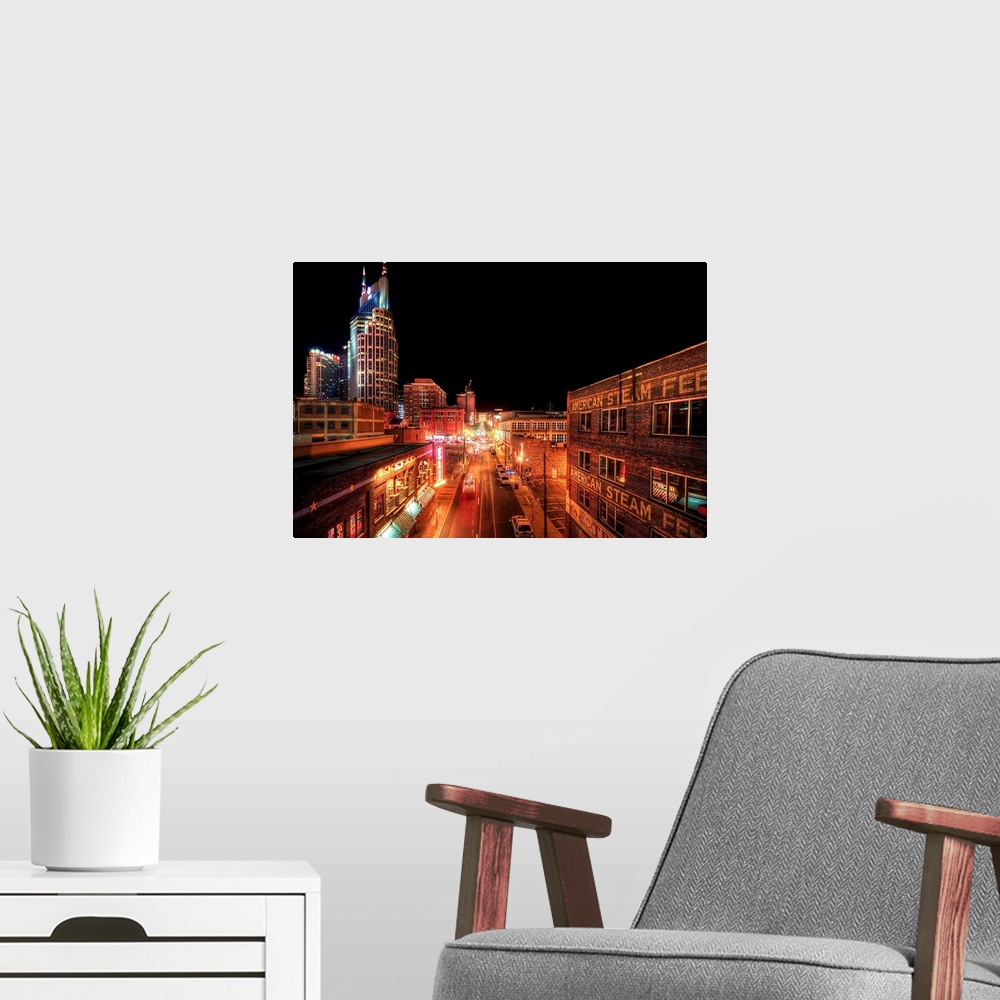 A modern room featuring Downtown Nashville at night, showing hustle and bustle of busy city.