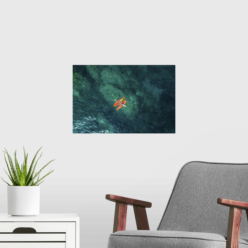 A modern room featuring Aerial picture of two girls practicing kayak in a paradise place of the costa brava beach with be...
