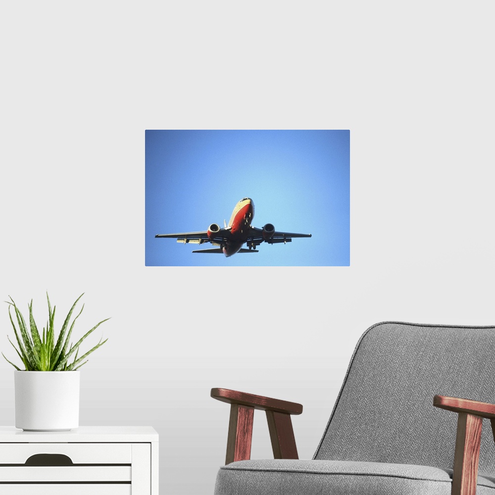 A modern room featuring Aeroplane flying across blue sky
