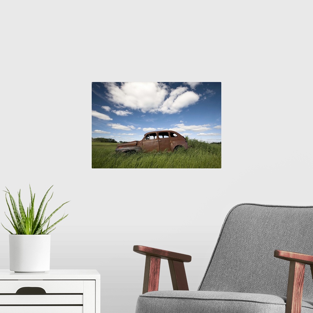 A modern room featuring An abandoned classic car in a prairie field