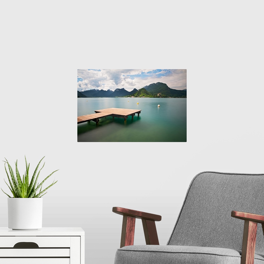 A modern room featuring Annecy lake and French Alps in background.