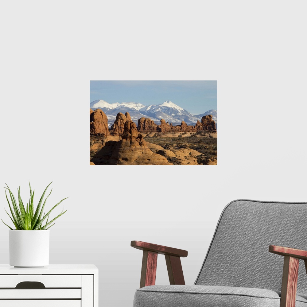 A modern room featuring The snow-capped montains of the La Sal Mountain range is visible in the background.