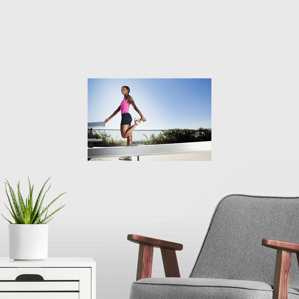 A modern room featuring Athletic woman stretching