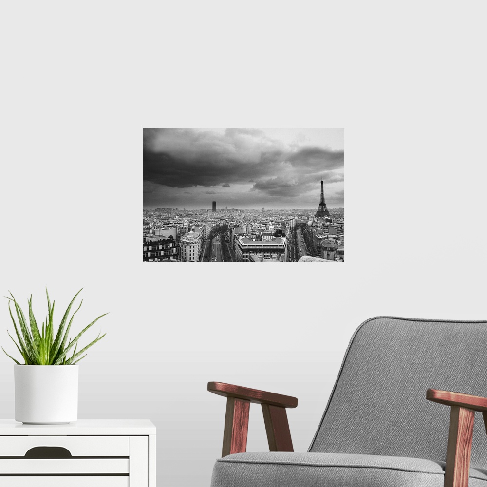 A modern room featuring black and white aerial view of an overcast sky above the Eiffel tower