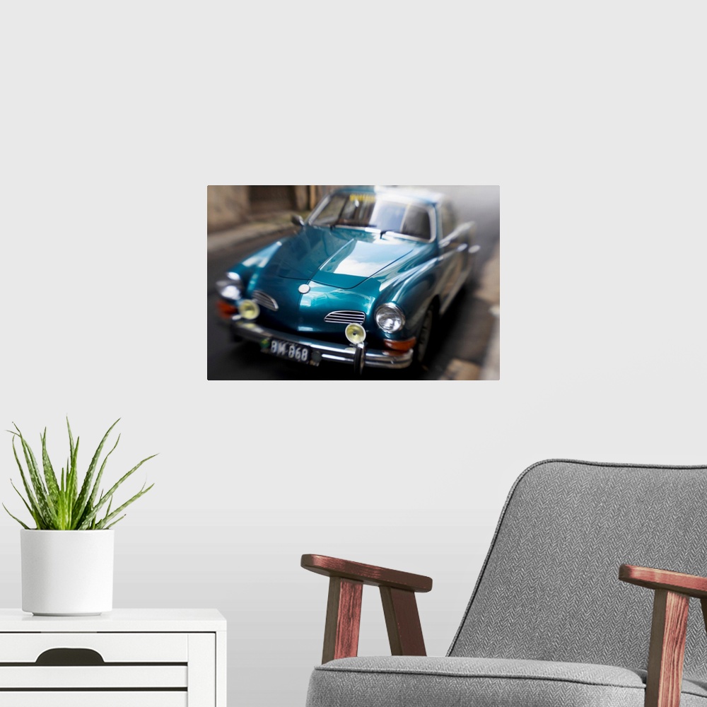 A modern room featuring Blurred Motion Shot of a Metallic Blue Classic Car