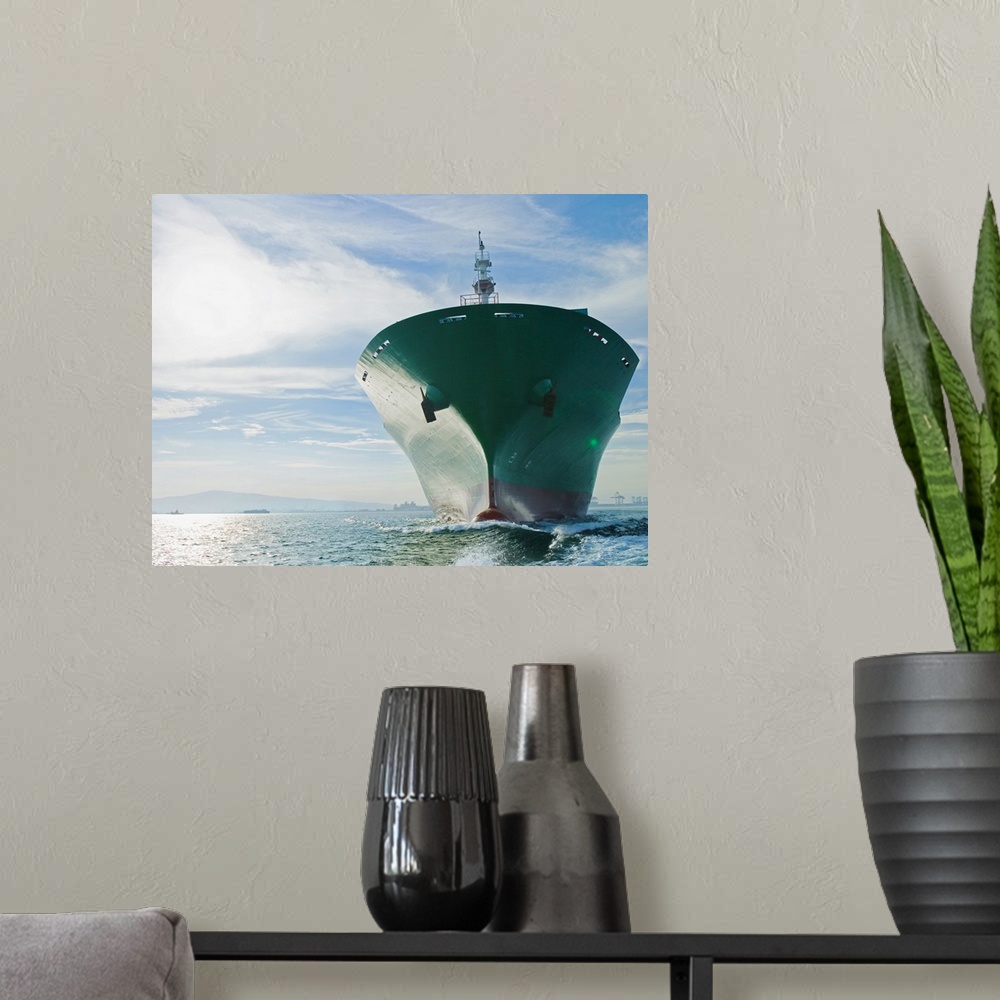 A modern room featuring Bow view of cargo ship sailing on ocean