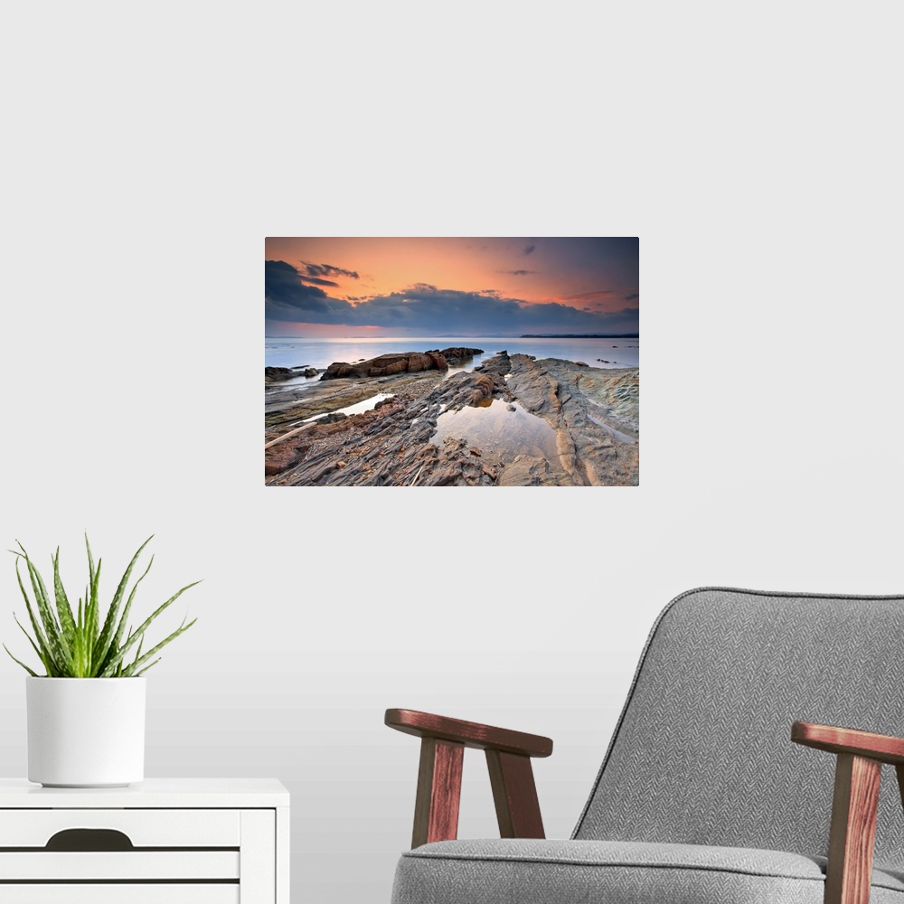 A modern room featuring Cabasson Beach at sunset