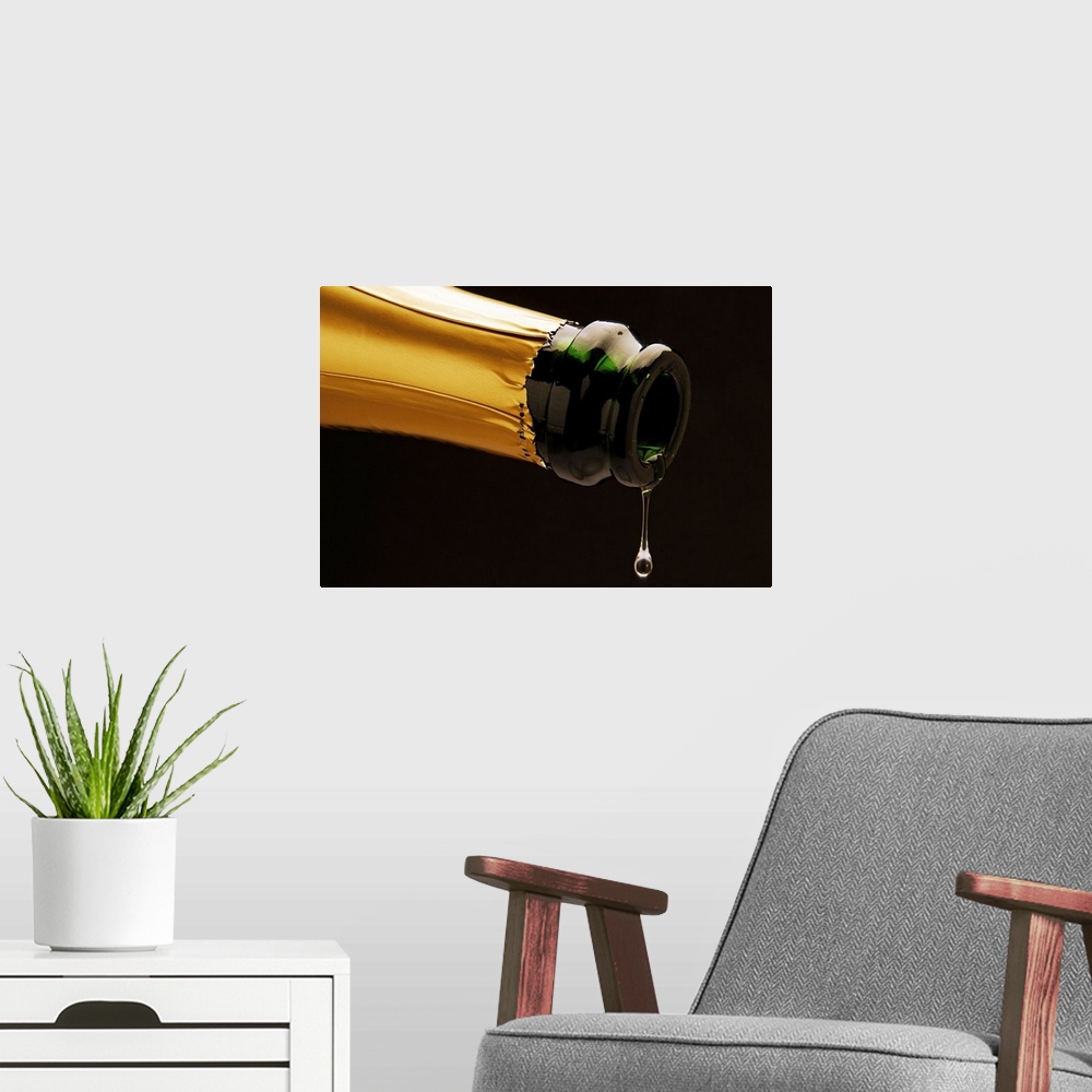 A modern room featuring Champagne drop dripping from bottle, close-up