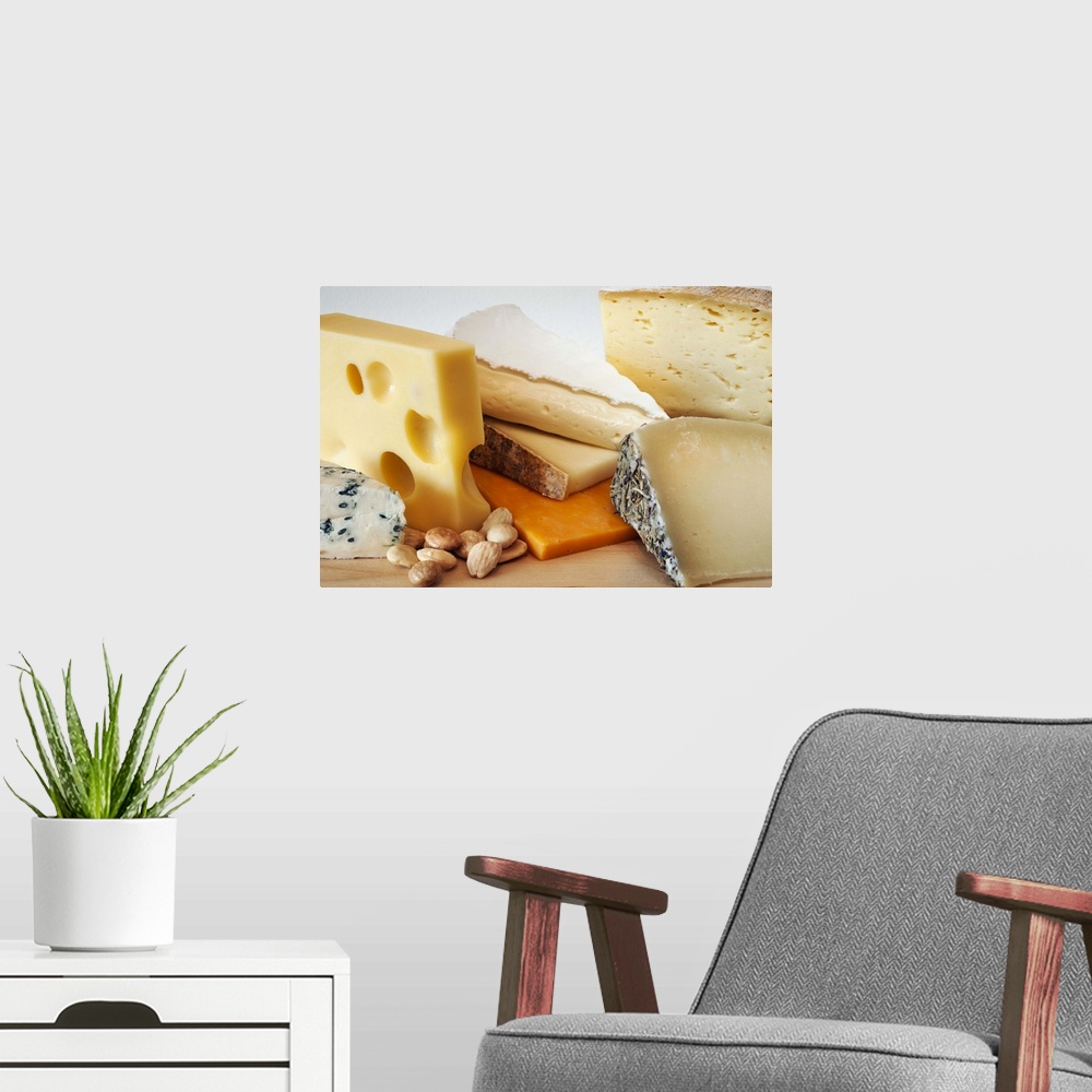 A modern room featuring Various cheeses on chopping board