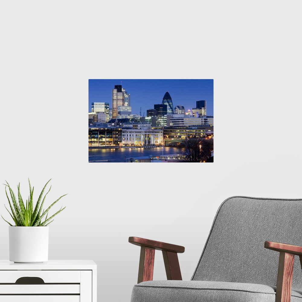 A modern room featuring Skyline across River Thames shows the City of London at twilight. Buildings include Heron Tower, ...