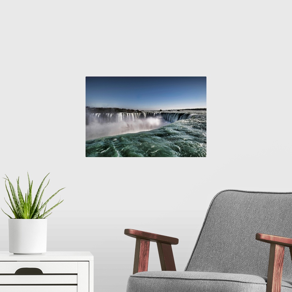 A modern room featuring Close up view of clear water of Horseshoe waterfalls in Canadian side of Niagara Falls.