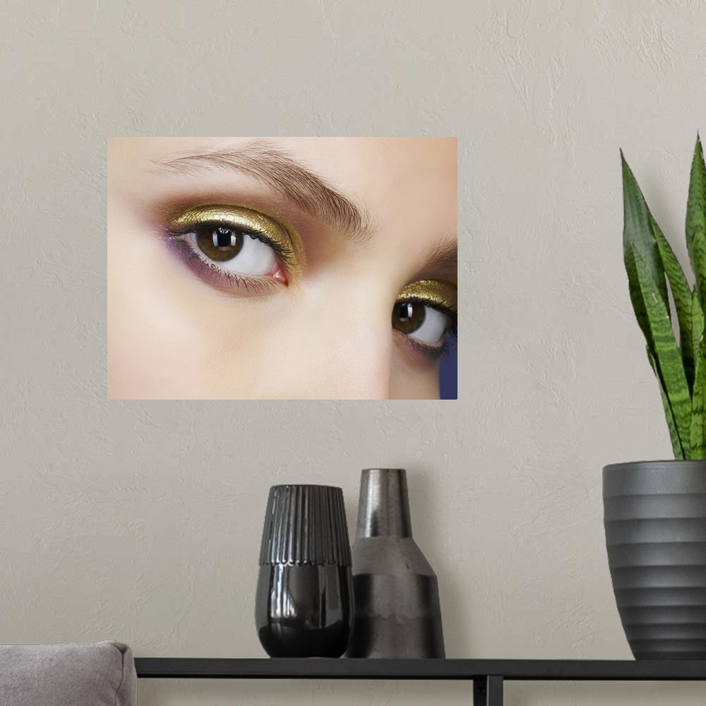 A modern room featuring Closeup of eyes with gold eyeshadow
