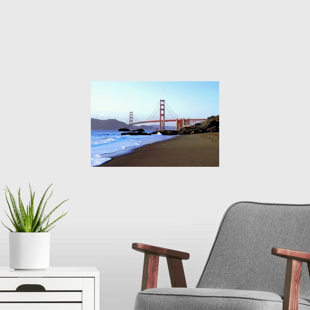 A modern room featuring Landscape photograph looking down the rocky shoreline toward the Golden Gate Bridge, beneath a bl...