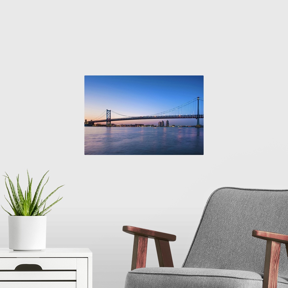 A modern room featuring Delaware River; Ben Franklin Bridge; dusk, I-676/US 30 highways