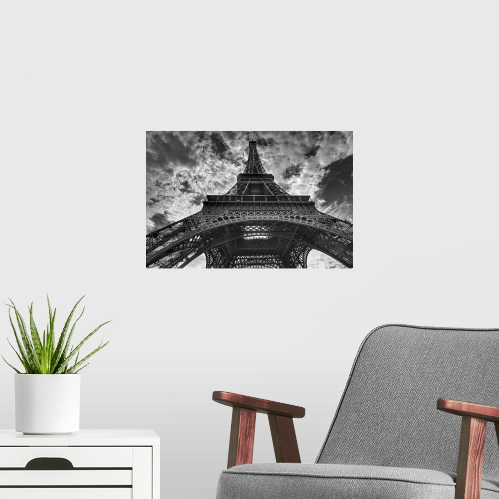 A modern room featuring Landscape, low angle photograph looking up one side of the Eiffel Tower, the background is a sky ...