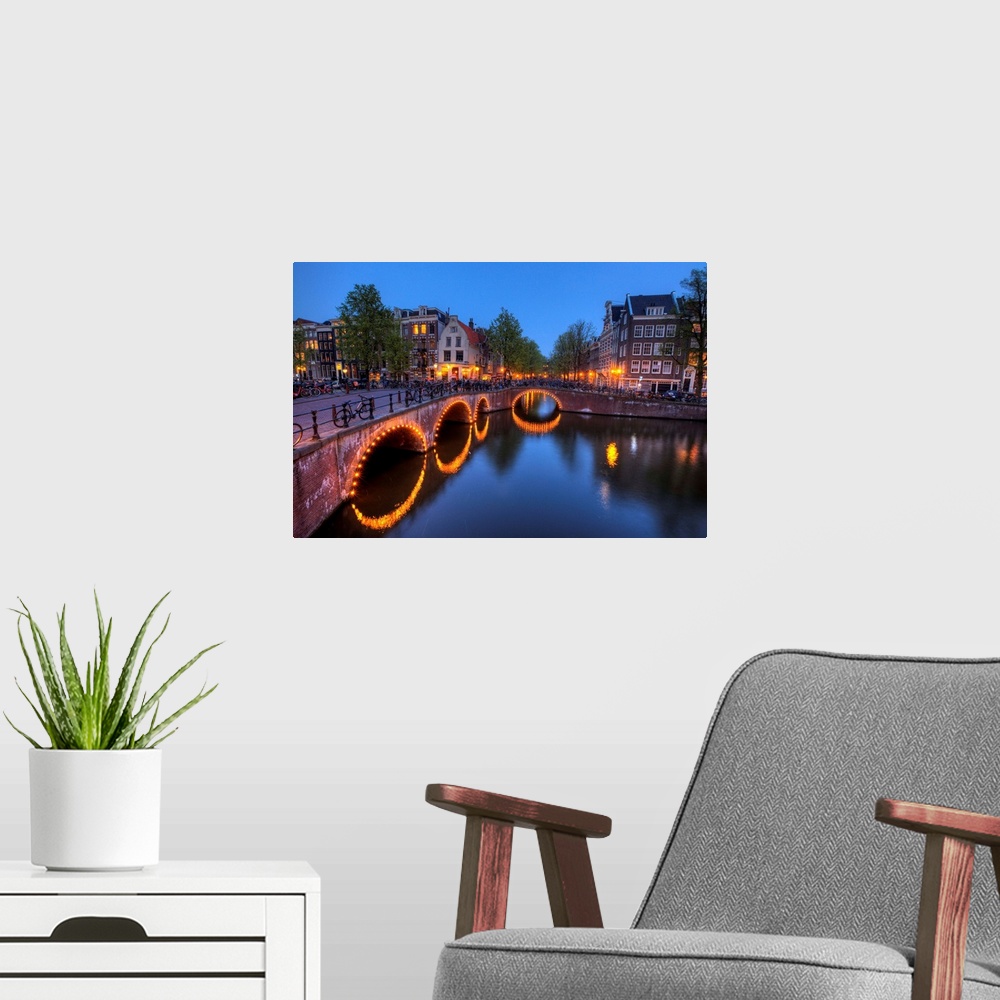 A modern room featuring Evening light old buildings and bridge along the many Canals of Amsterdam, Netherlands, at dusk t...