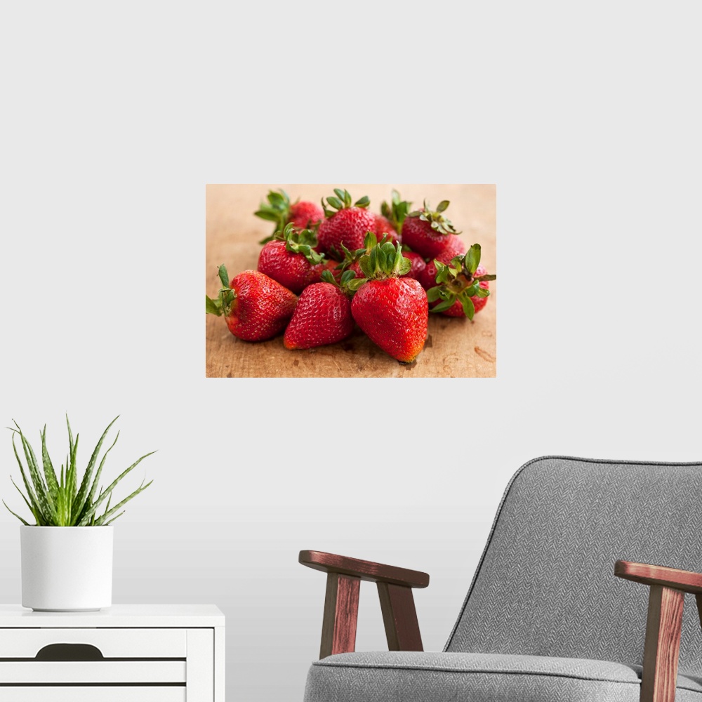 A modern room featuring Docor perfect for the kitchen of a batch of strawberries piled together on a wooden surface.