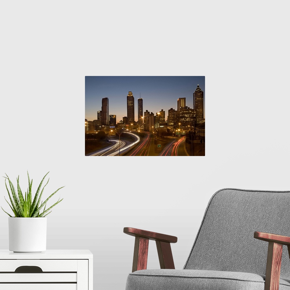 A modern room featuring USA, Georgia, Atlanta, traffic on highways leading towards downtown city at dusk, long exposure