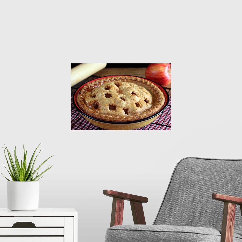 A modern room featuring Home baked apple pie on cooling rack with apple and rolling pin