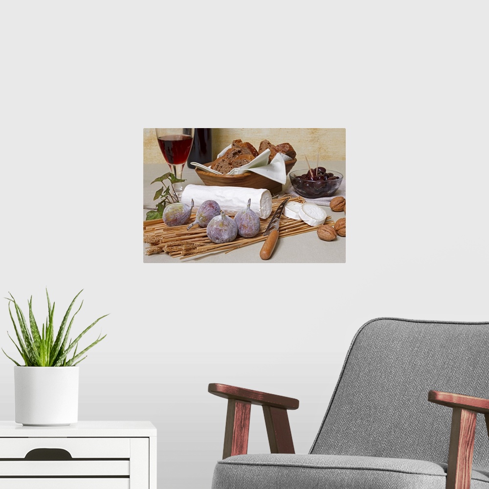 A modern room featuring Log of goat's cheese with figs, nuts, olives, bread and red wine