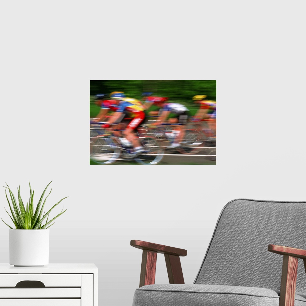 A modern room featuring Male cyclist riding bicycle (blurred motion)