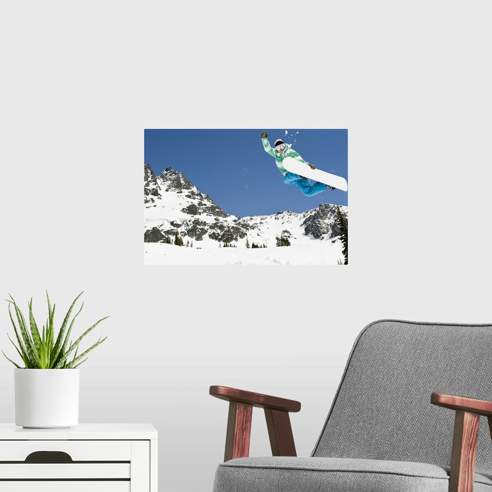 A modern room featuring male snowboarder jumping in air