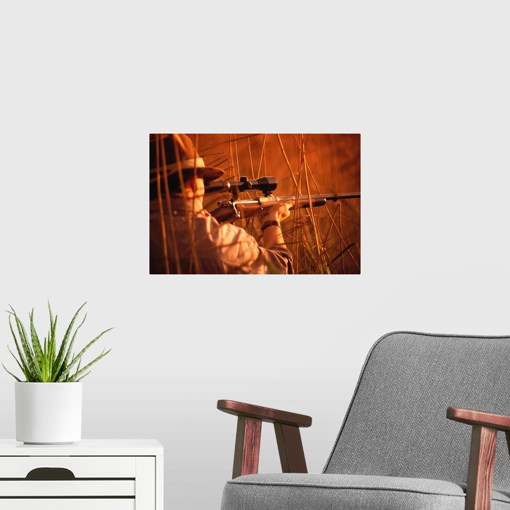 A modern room featuring Man aiming with shotgun in forest, rear view (cross-processed)