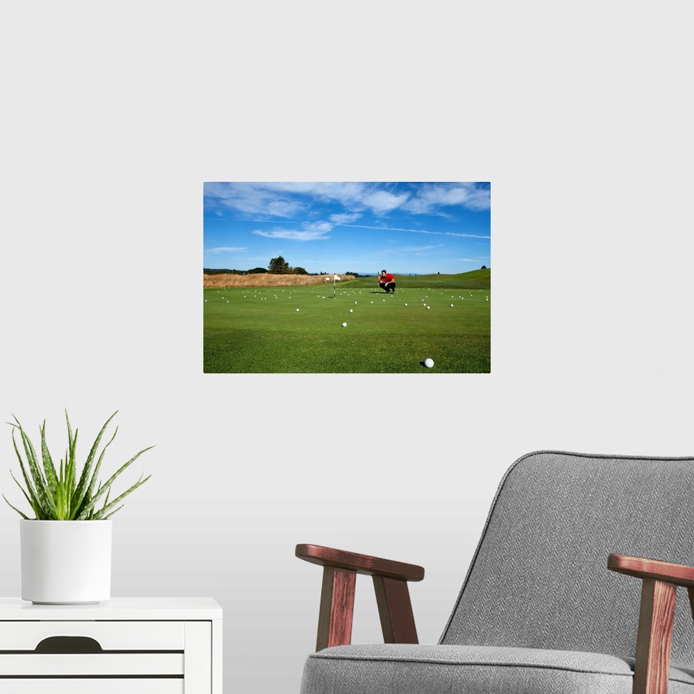 A modern room featuring Man lining up a putt while golfing.