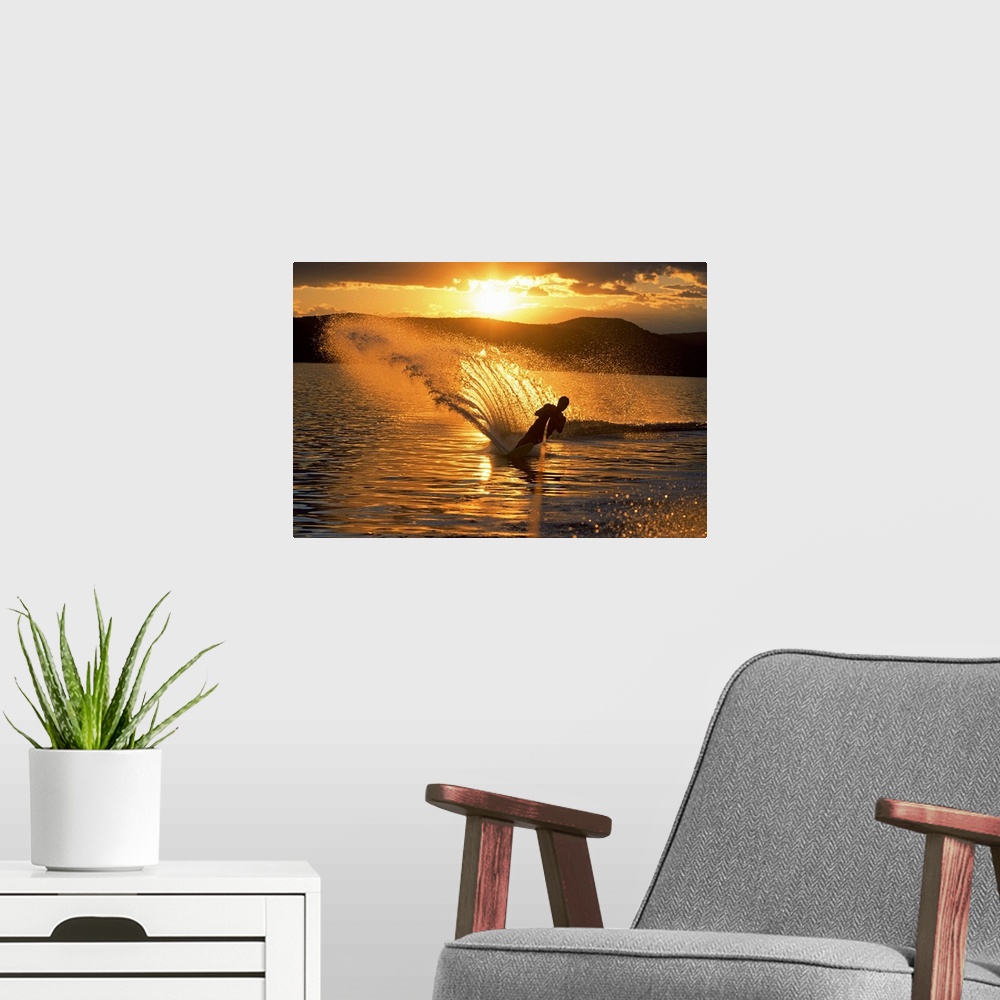A modern room featuring Man waterskiing at dusk