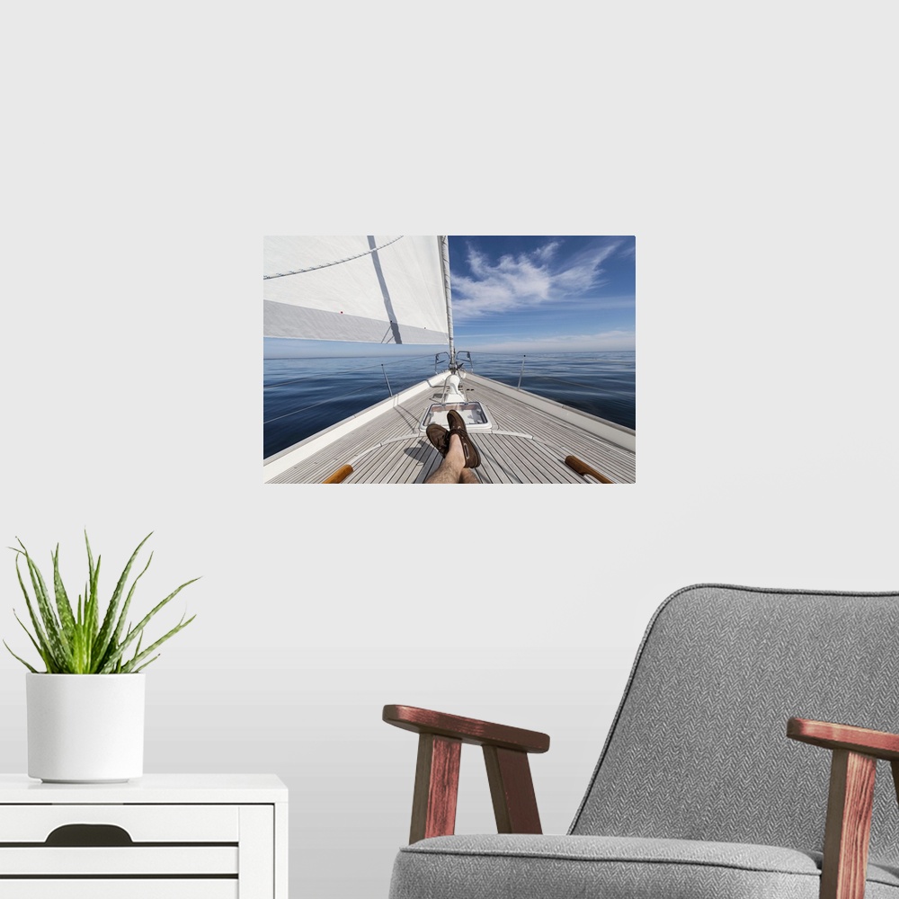 A modern room featuring Man's feet crossed on 62 ft sailboat