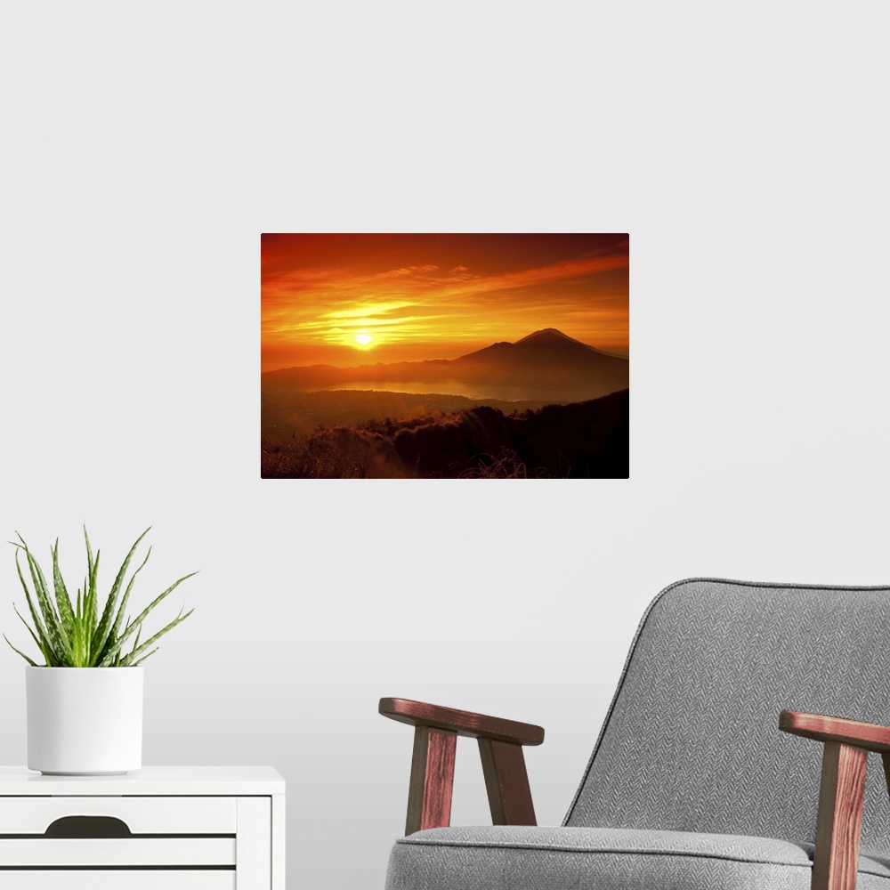 A modern room featuring Mount Batur with Danau Batur during sunrise.