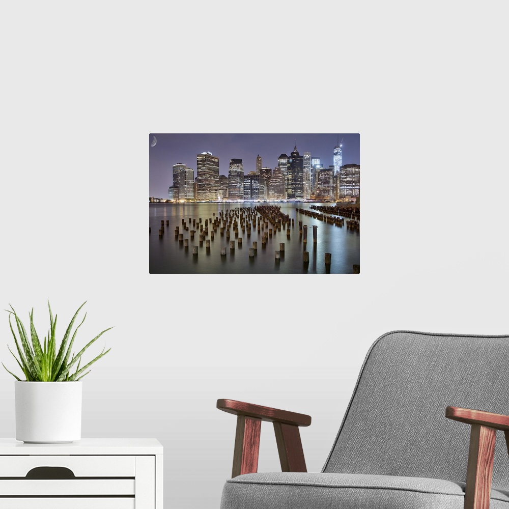 A modern room featuring This is the beautiful New York skyline at night as seen from Brooklyn park