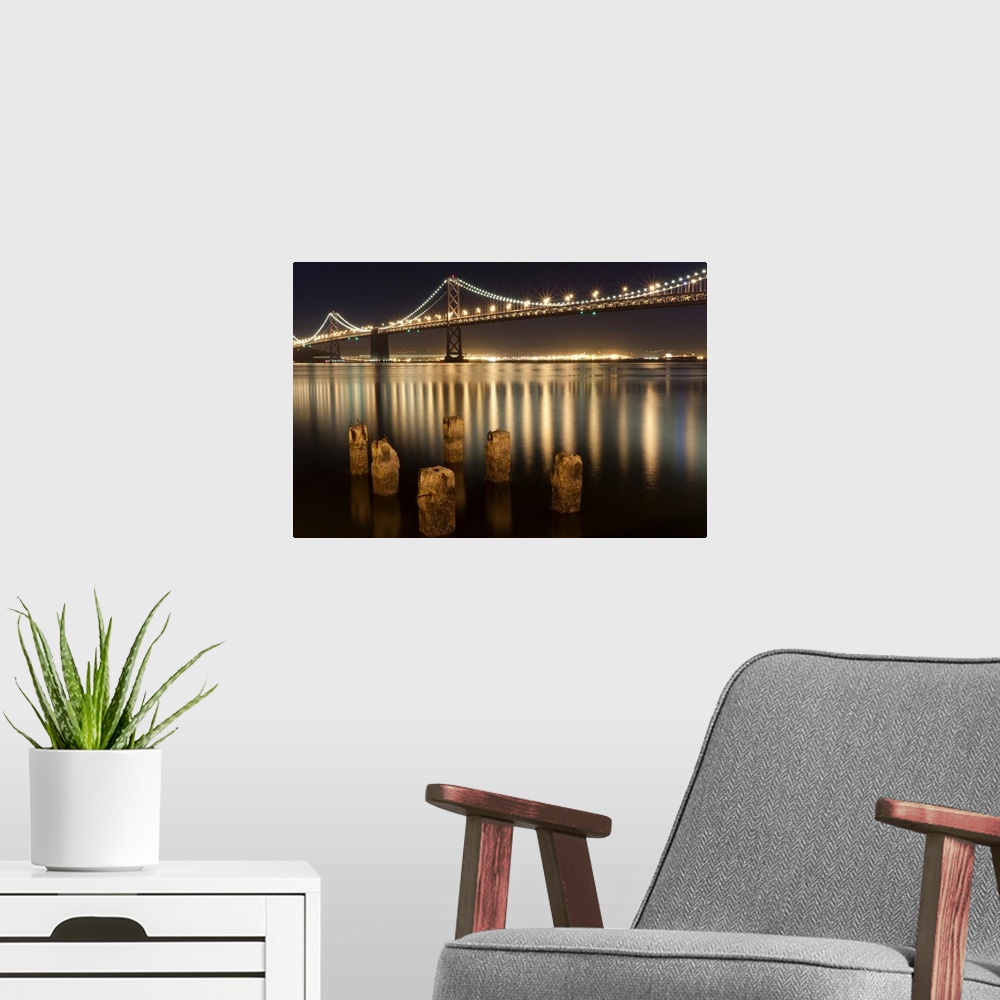 A modern room featuring Oakland Bay Bridge night reflections.