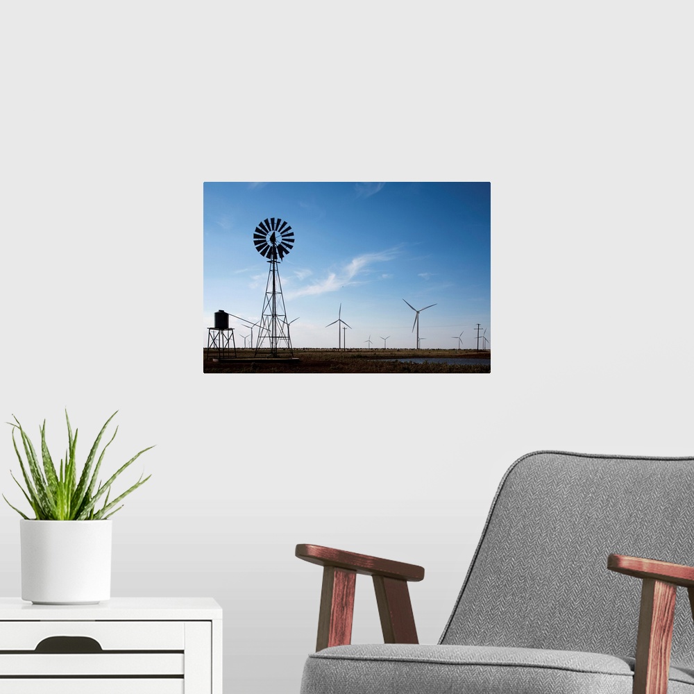 A modern room featuring USA, Texas, Vega, Old ranch windmill and water pump beneath array of wind power generating turbin...
