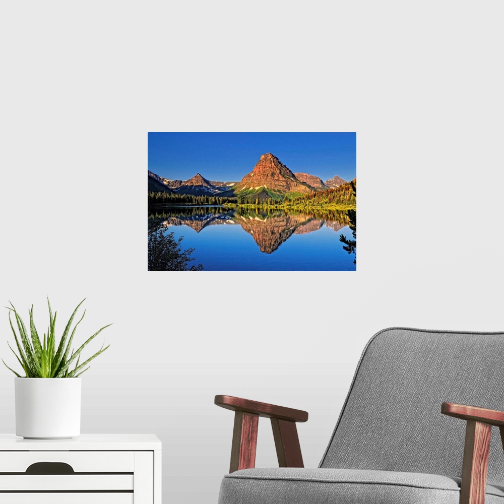 A modern room featuring An image from Glacier Park's Two Medicine area.Shown here is Painted Teepee mountain, stunning Mt...