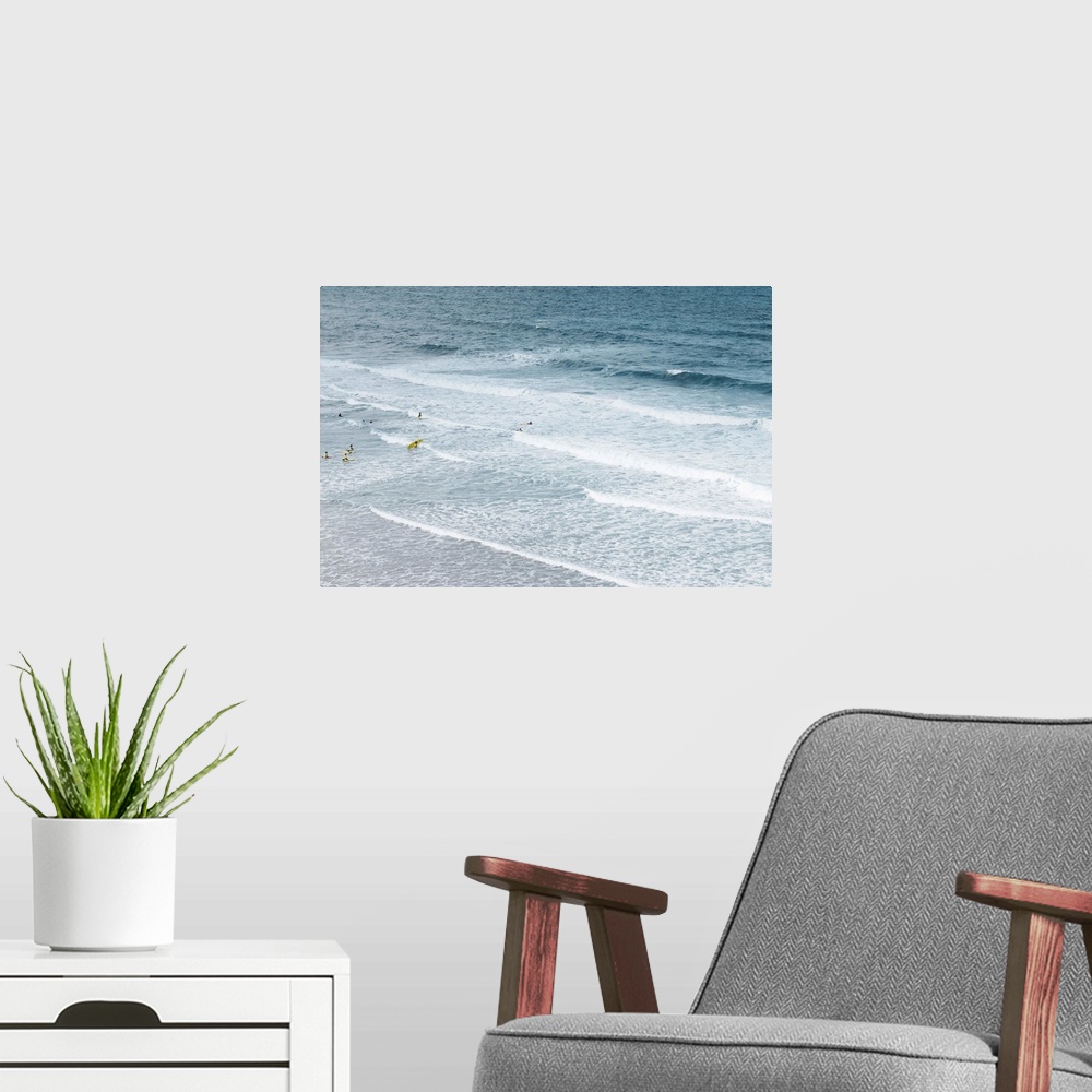 A modern room featuring People learning to surf in atlantic ocean.