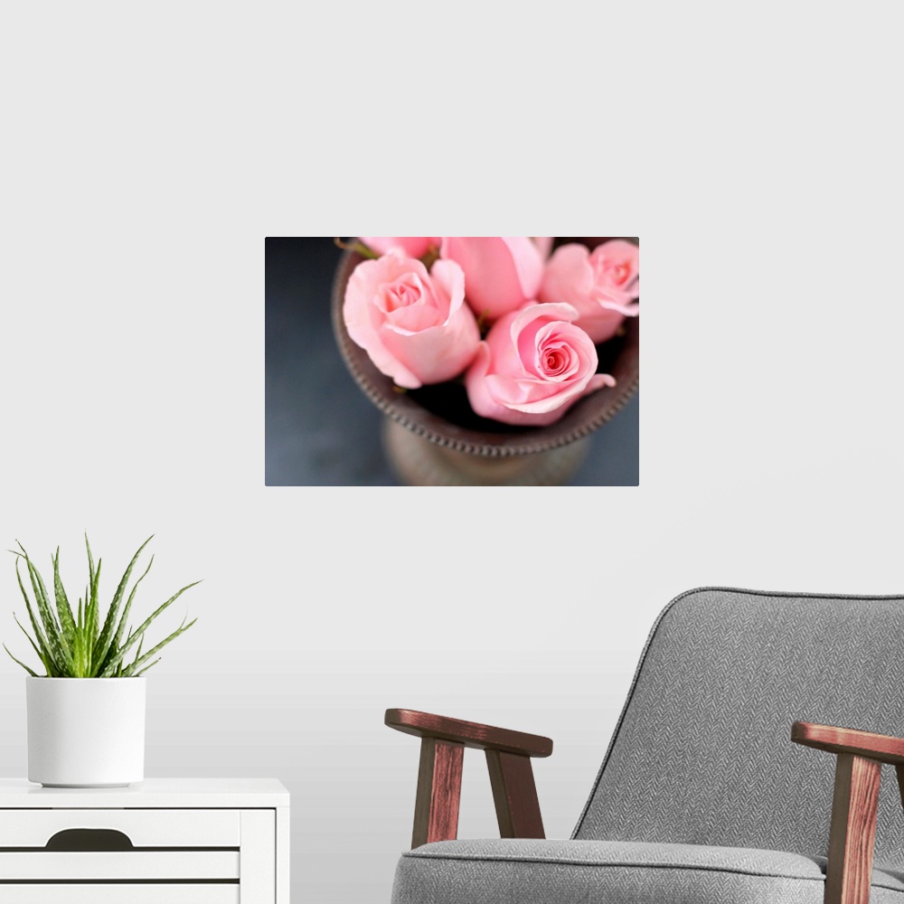 A modern room featuring Pink roses in vase from above.