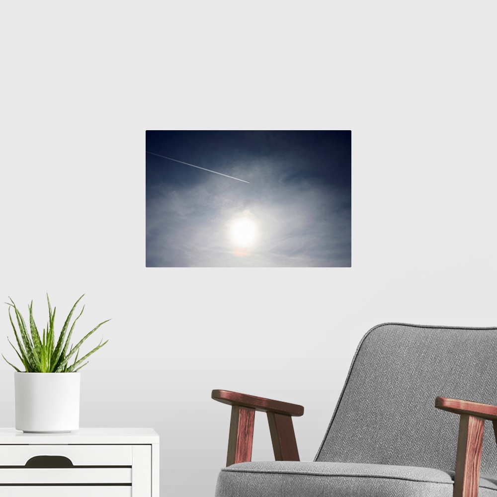 A modern room featuring Plane and Vapor trail flying above sun.