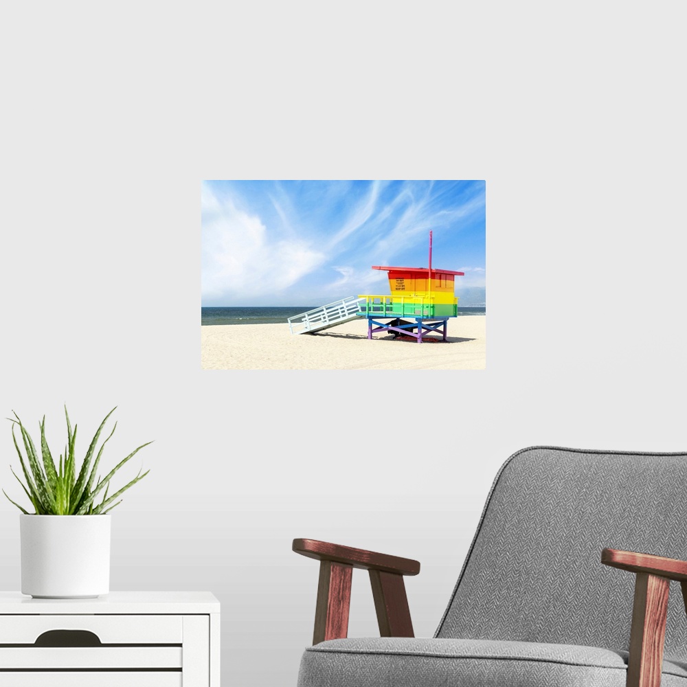 A modern room featuring A vibrant photo of a lifeguard tower in the colors of the pride flag, located at Venice Beach, Lo...