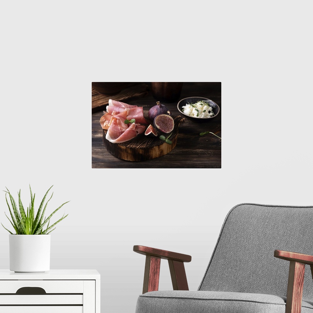 A modern room featuring Prosciutto slices with figs on a dark wooden background, appetizer from dry cured ham. Rustic sty...