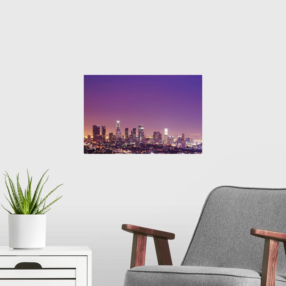 A modern room featuring Skyscrapers at dusk.