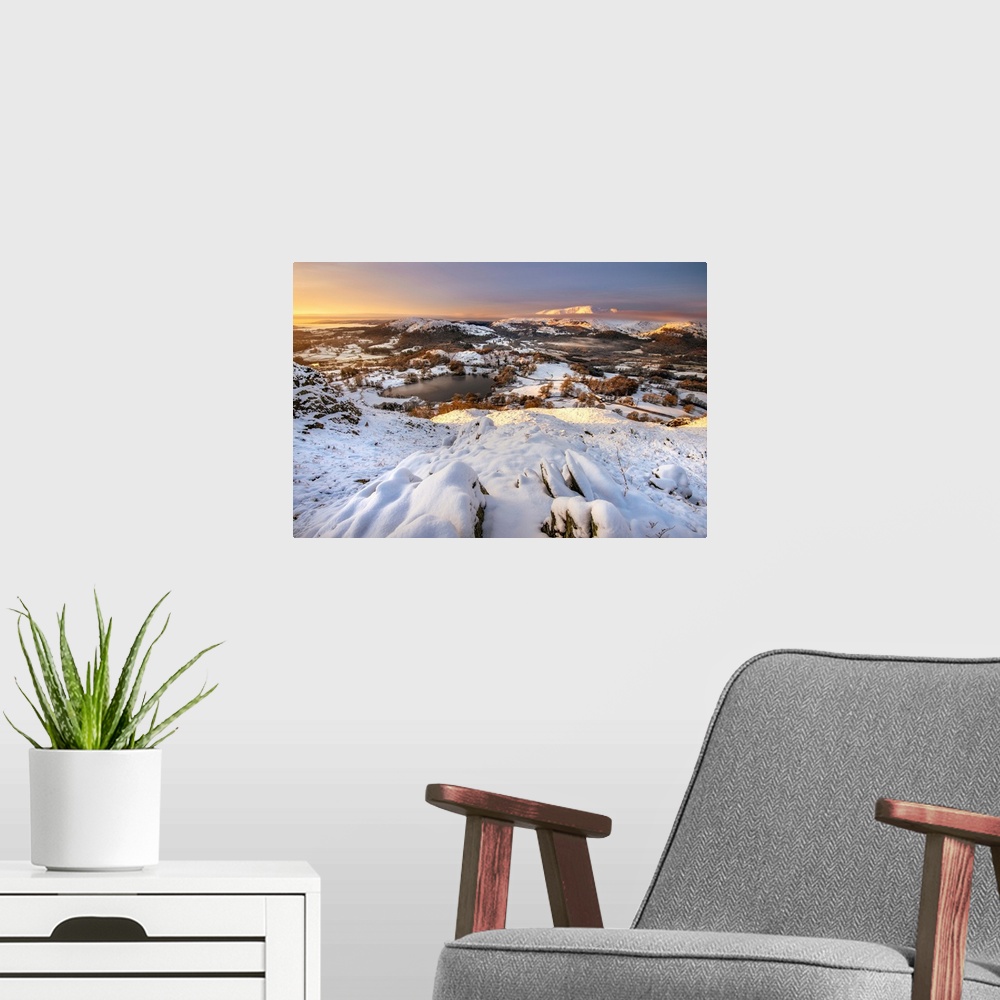 A modern room featuring View from Loughrigg Fell on a winter morning with golden light bathing the snow covered landscape...