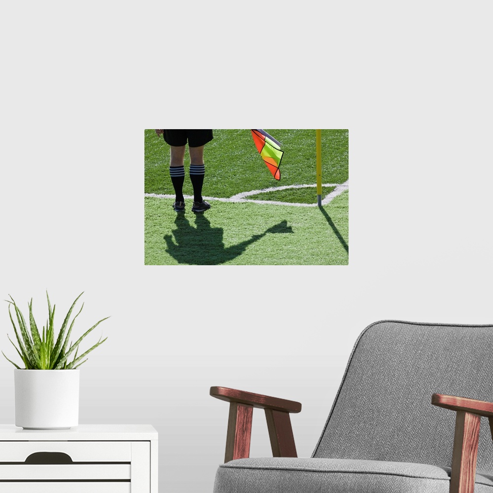 A modern room featuring Soccer referee holding flag