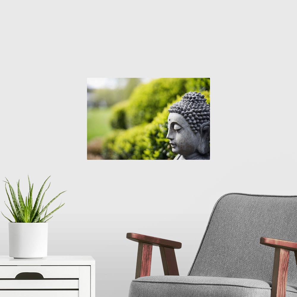 A modern room featuring Statue of Buddha in a garden