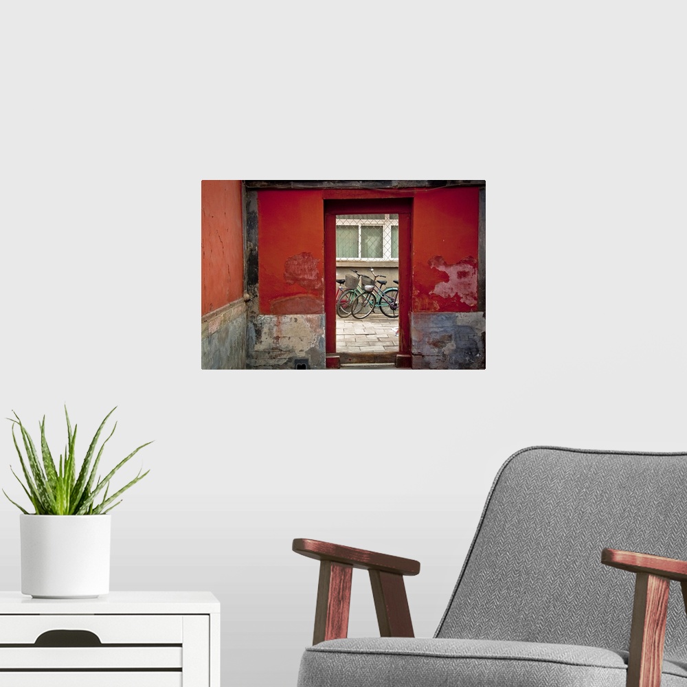 A modern room featuring Big, horizontal photograph of a clear glass doorway surrounded by red and grey cement walls.  Thr...